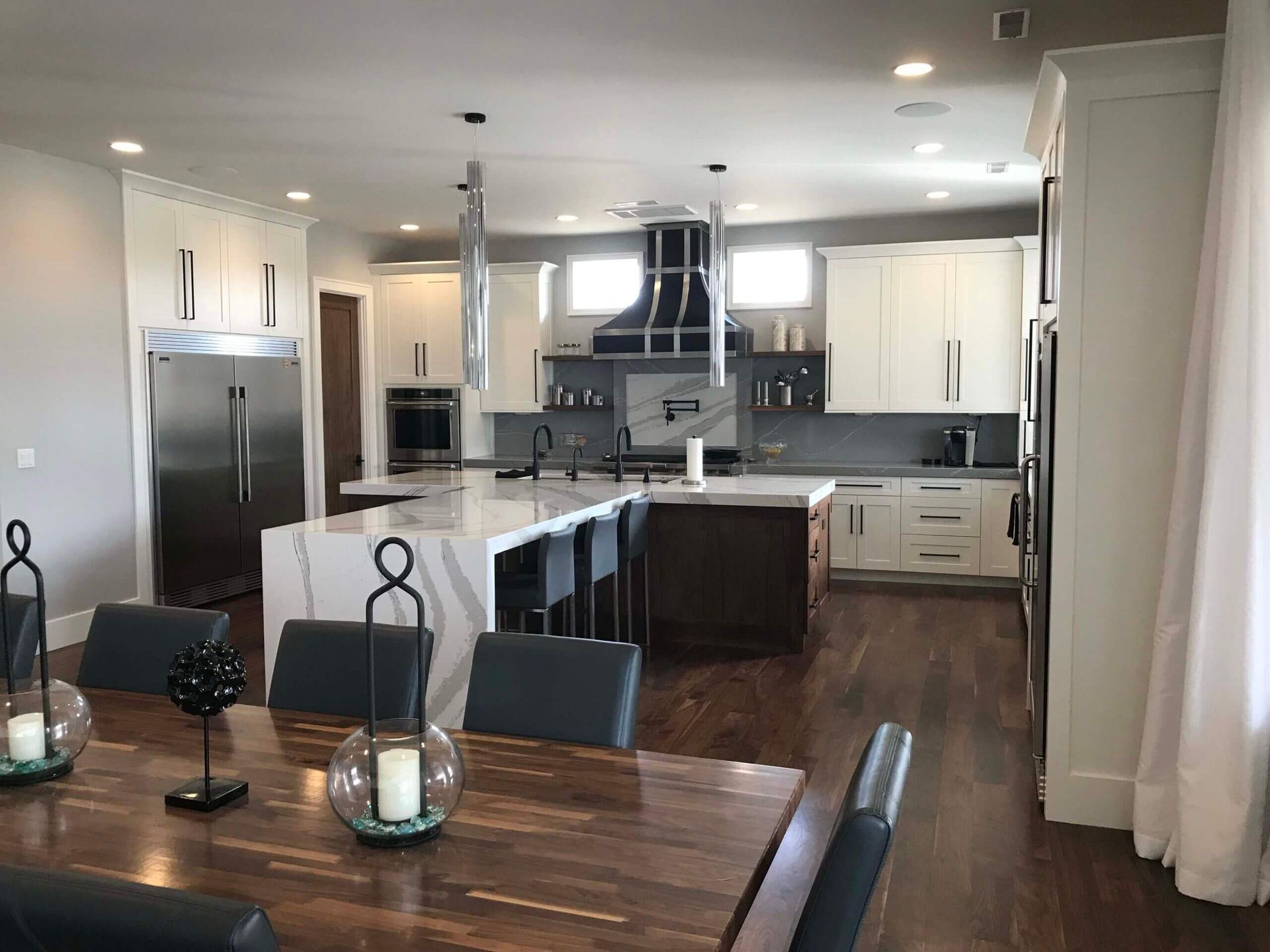 A kitchen and dining room in a house with a table and chairs. Custom cabinets Columbia Missouri 