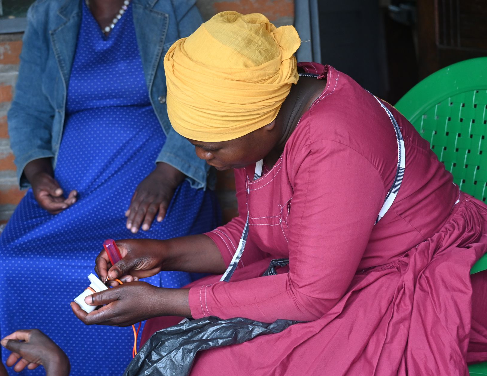 A programme participant assembles electrical components during a hands-on solar installation practical, applying technical skills as part of a vocational training session that supports employment and entrepreneurship.
