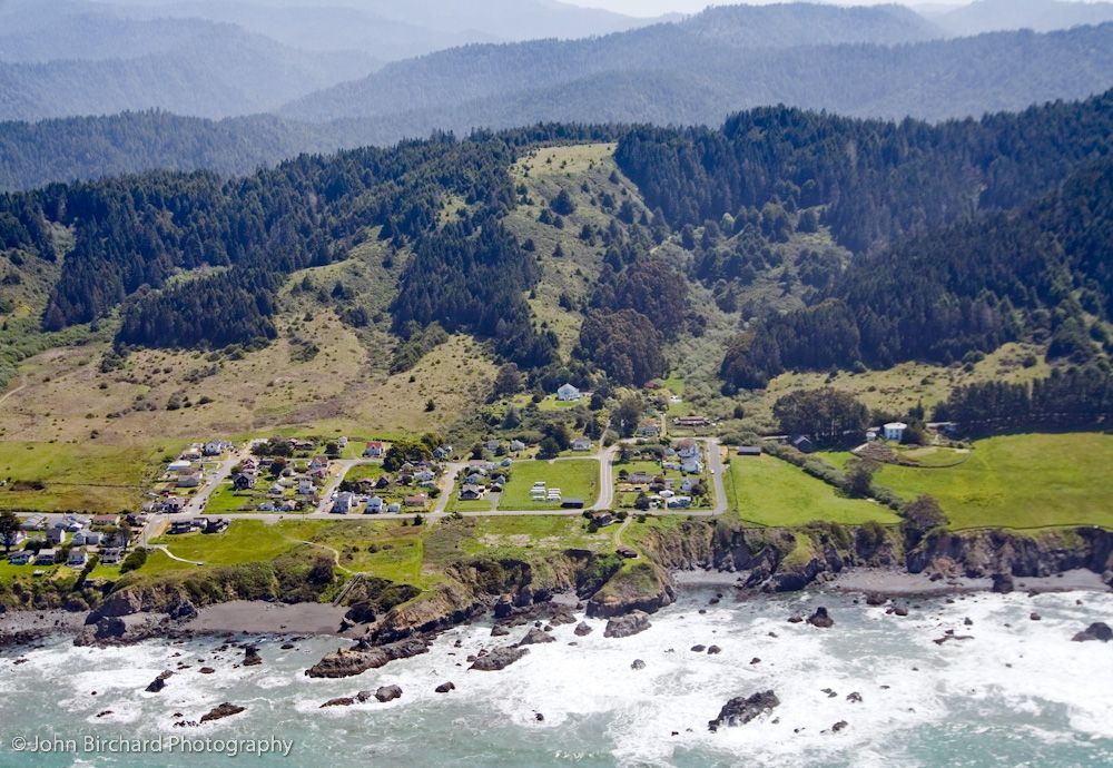 An aerial view of a residential area near the ocean