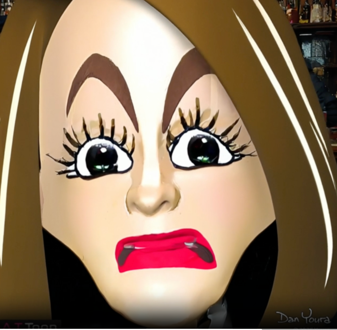 Close-up of a cartoonish face with wide eyes, raised brows, and bright red lips on a dark background