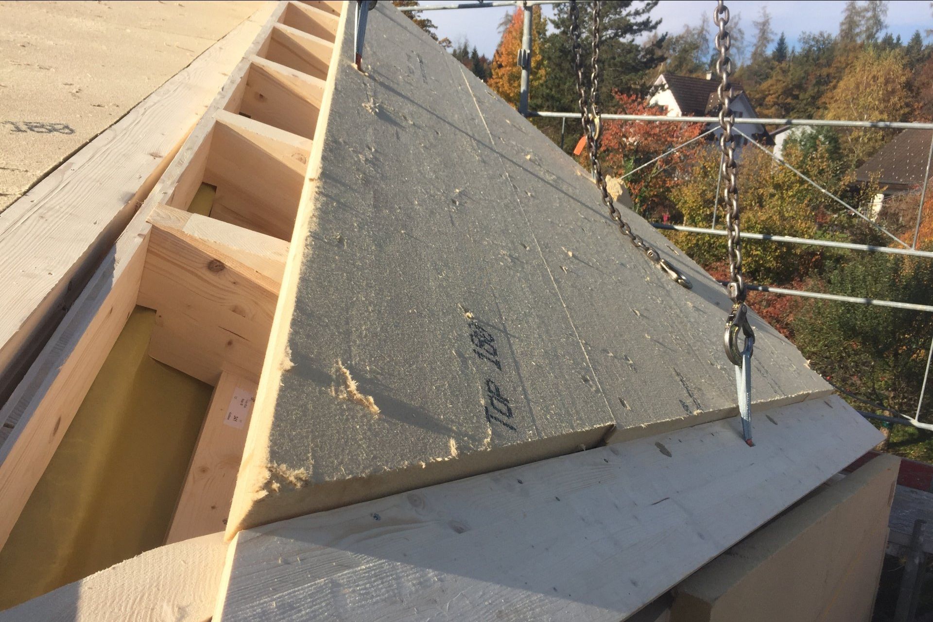 Das Dach eines Hauses wird gebaut und hat eine dreieckige Dachform.