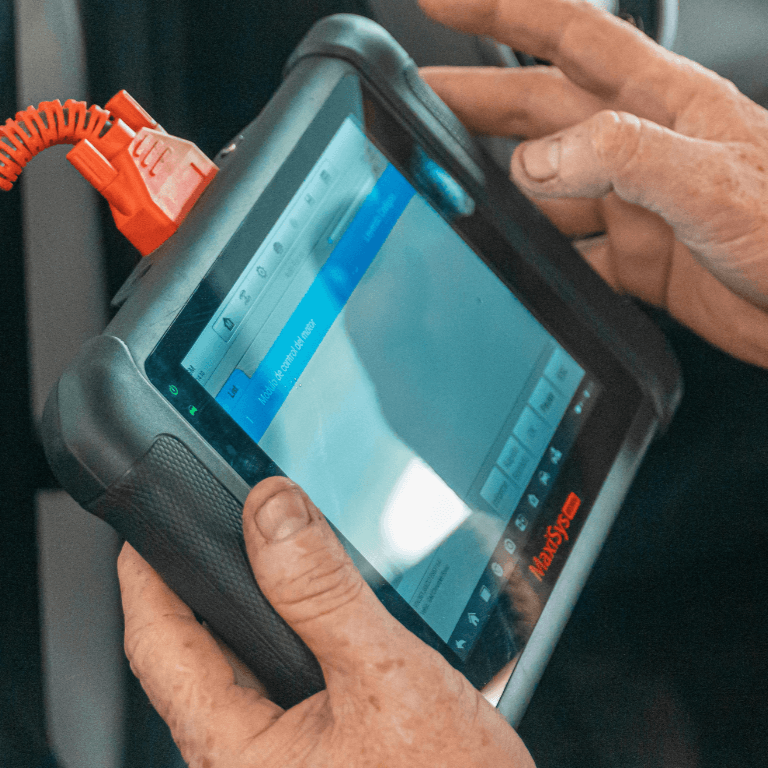 diagnostic scanning tool held by a mechanic