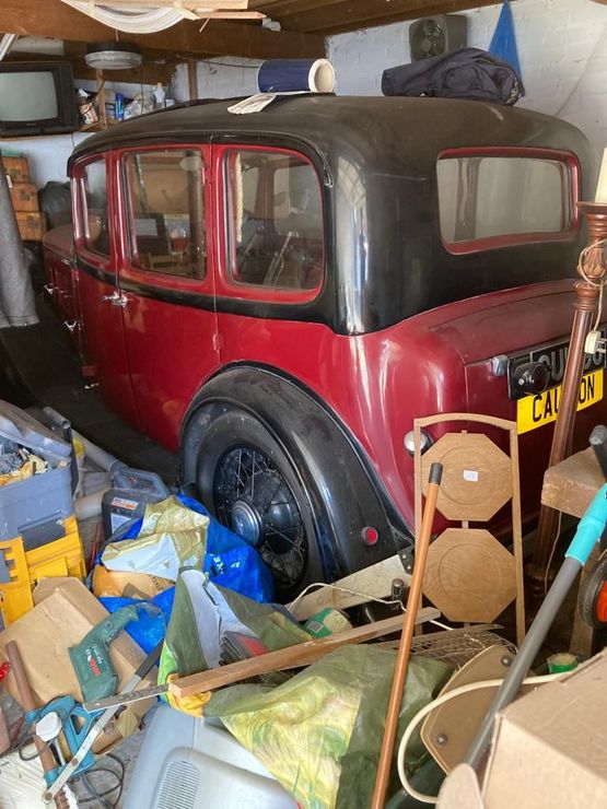 Image of full garage including a very old black and red car Image of garage with very old car before Terry's house clearance have removed all items