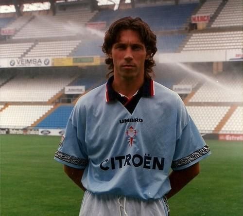 A man in a light blue citroen jersey stands on a field
