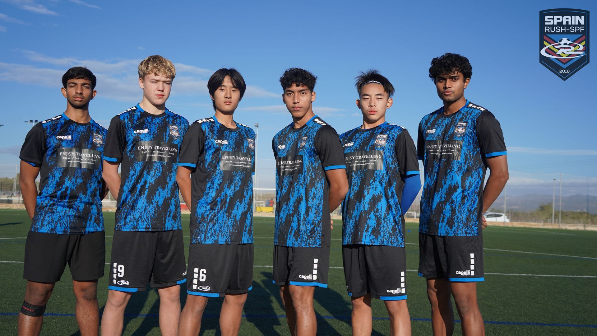 A group of young men are standing next to each other on a soccer field.