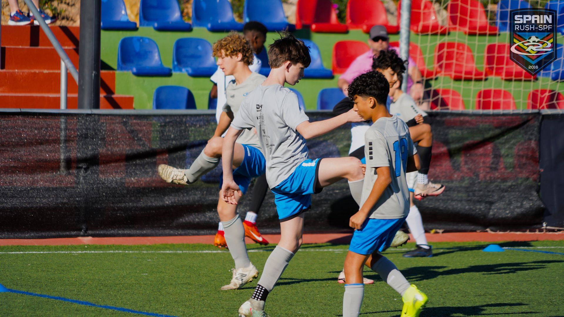 A group of young boys are playing soccer on a field.