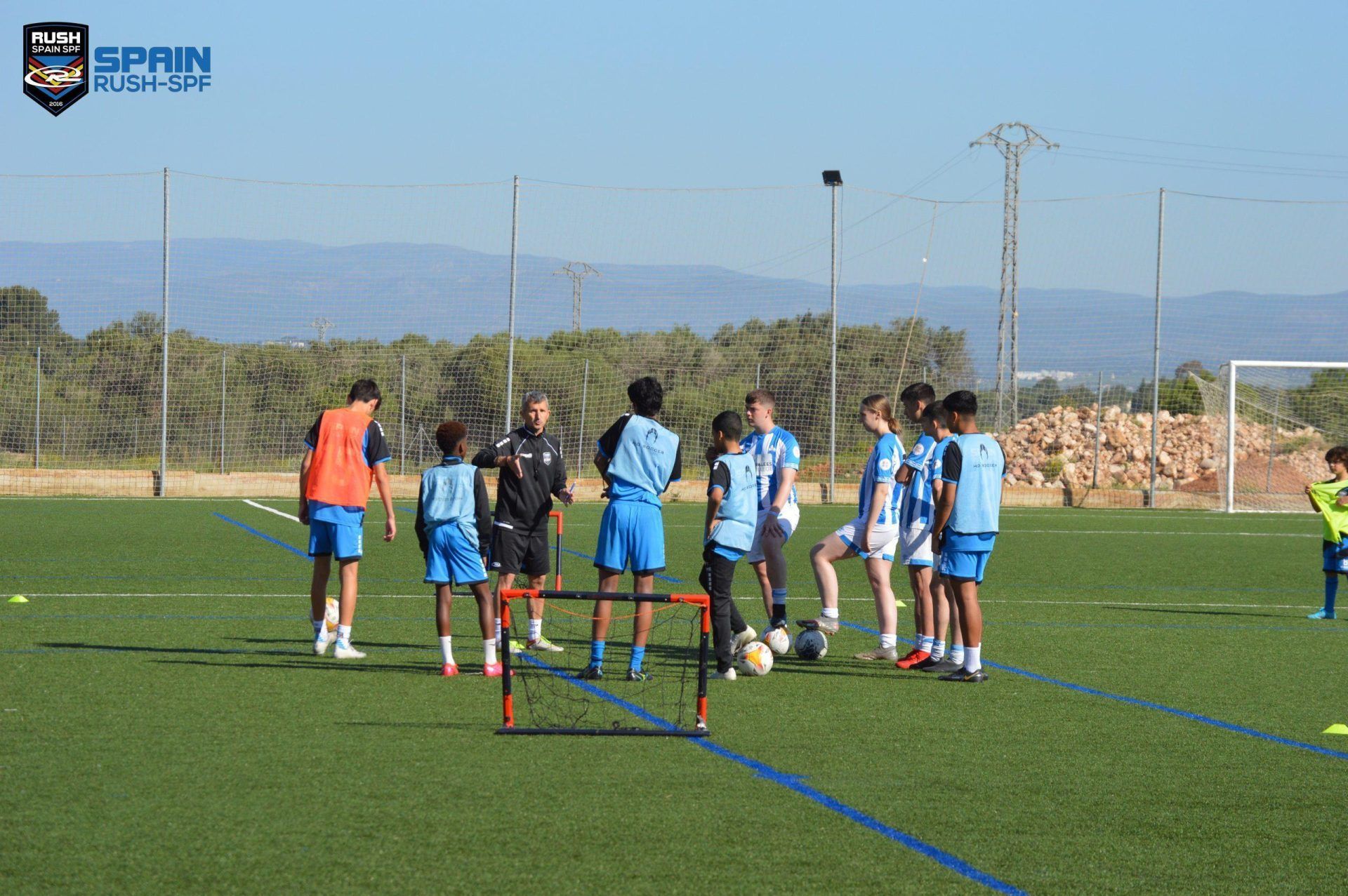 A group of soccer players are standing on a field with the word rugby in the background