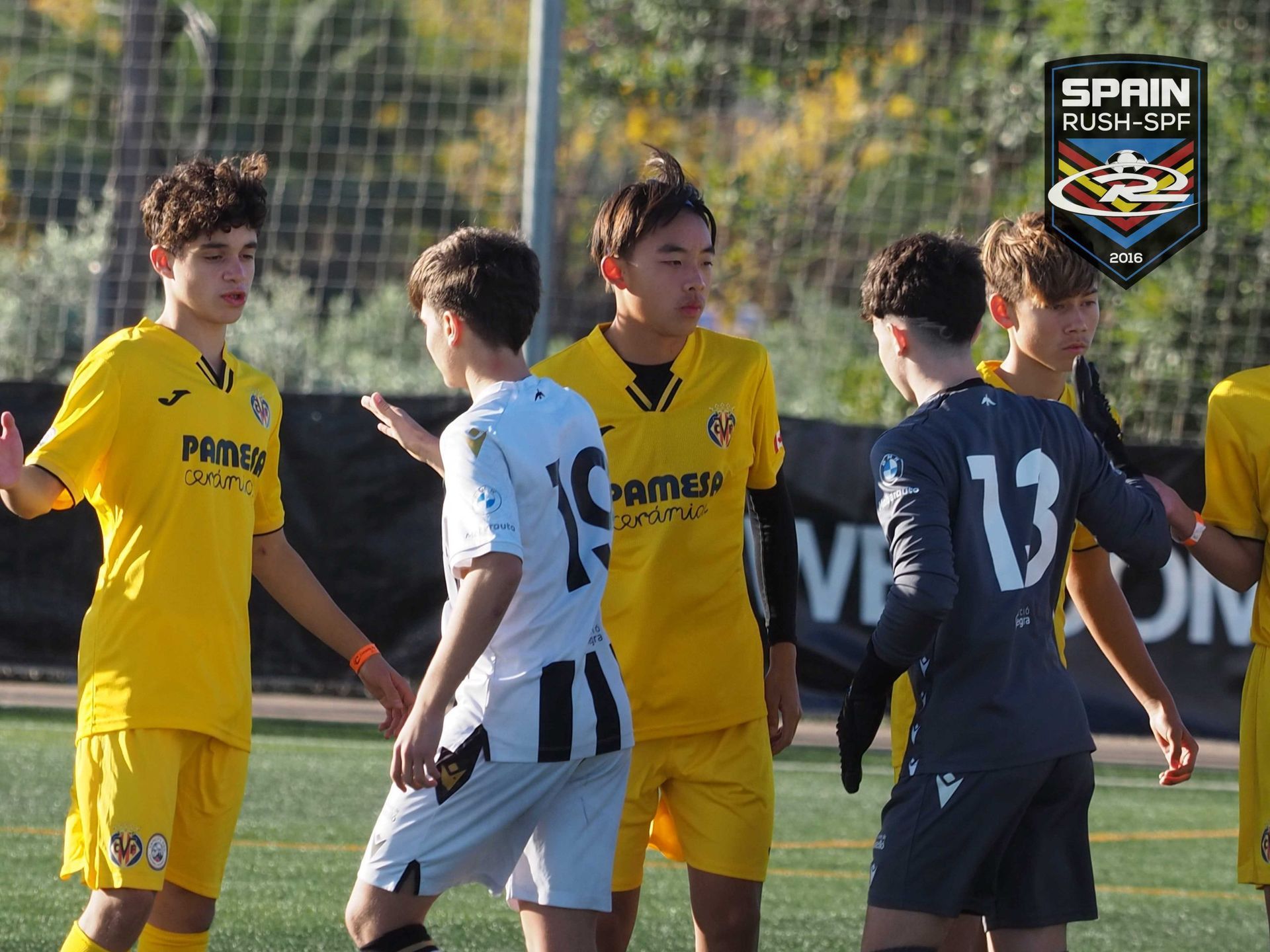 A group of young boys are playing soccer on a field.