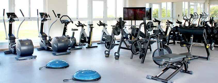 A gym filled with a variety of exercise equipment.