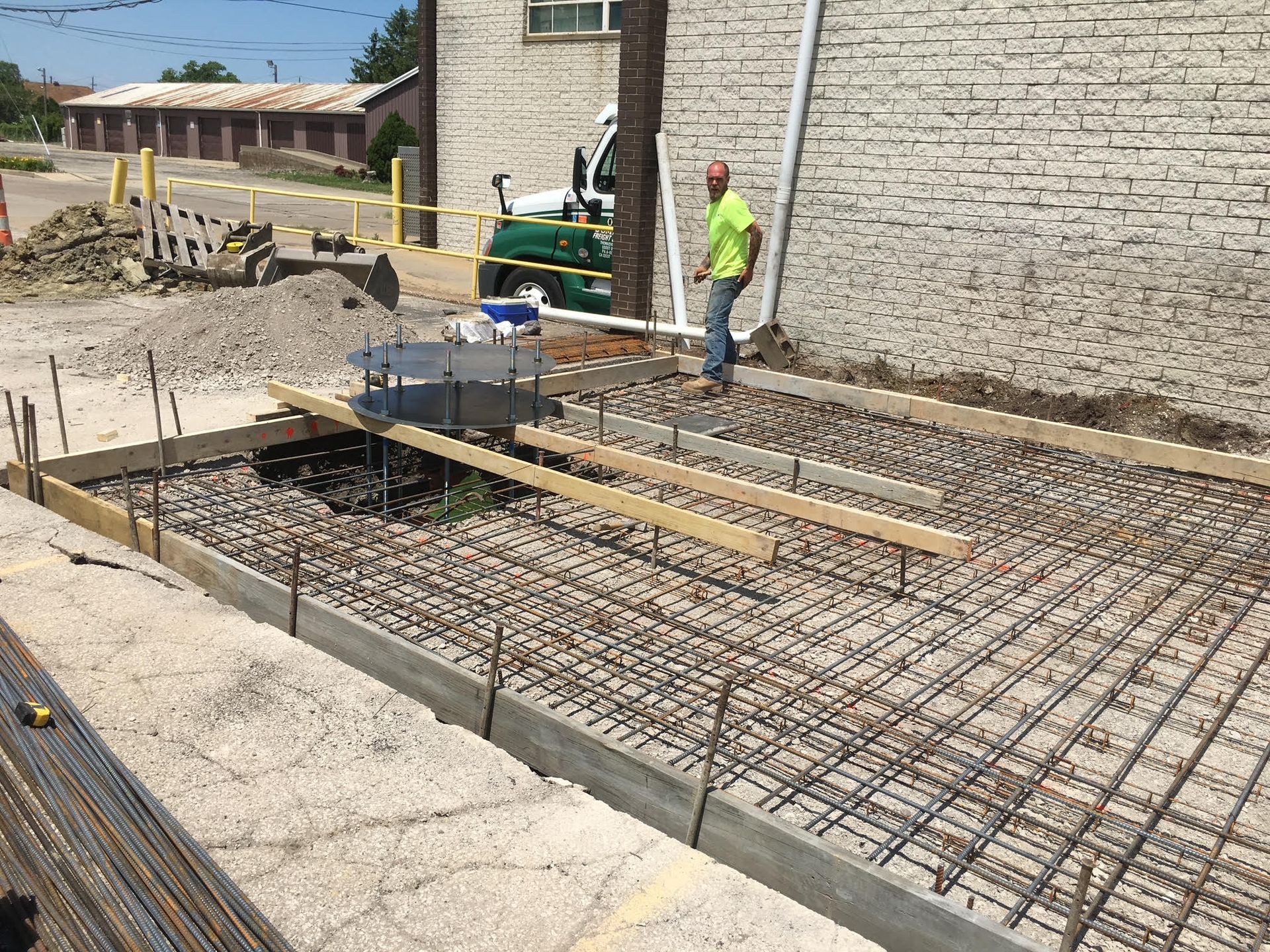Freshly poured gray concrete walkway at a construction site.