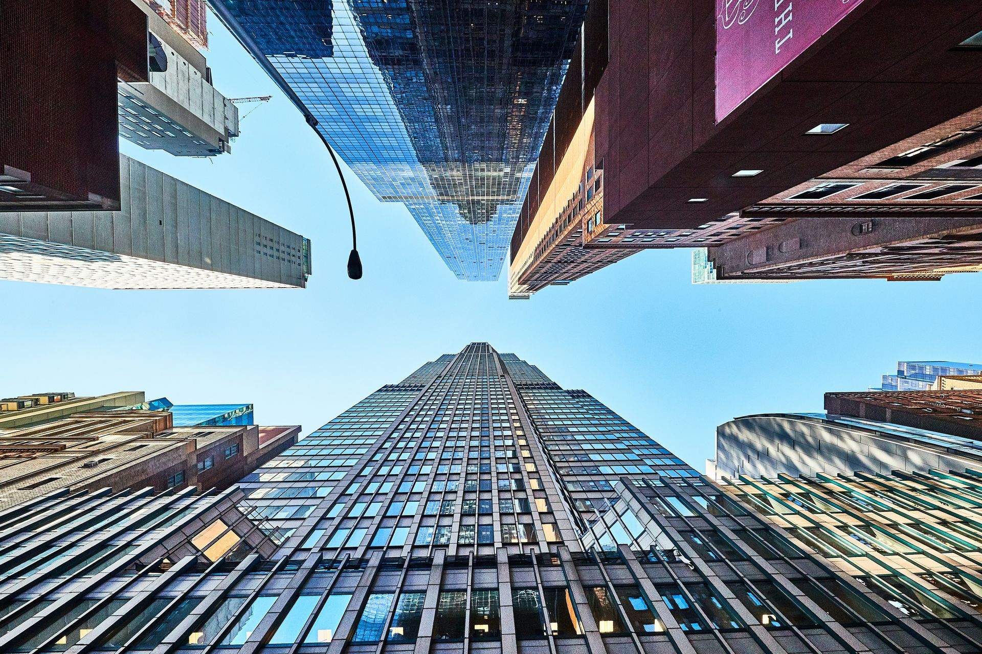 Looking up at a very tall building in a city.
