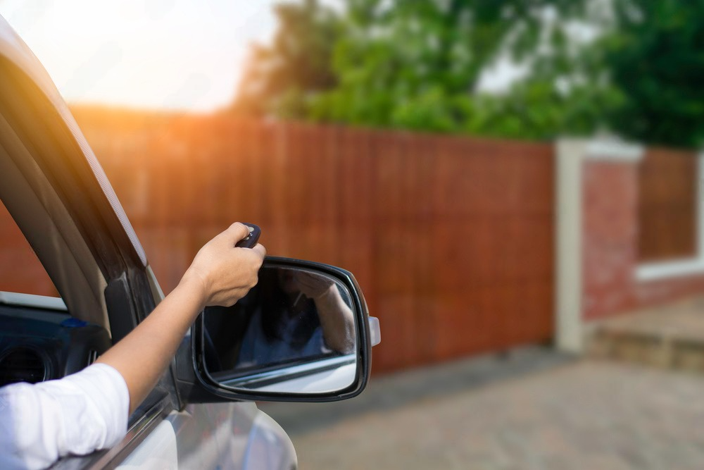 a woman is holding a remote control while driving a car .