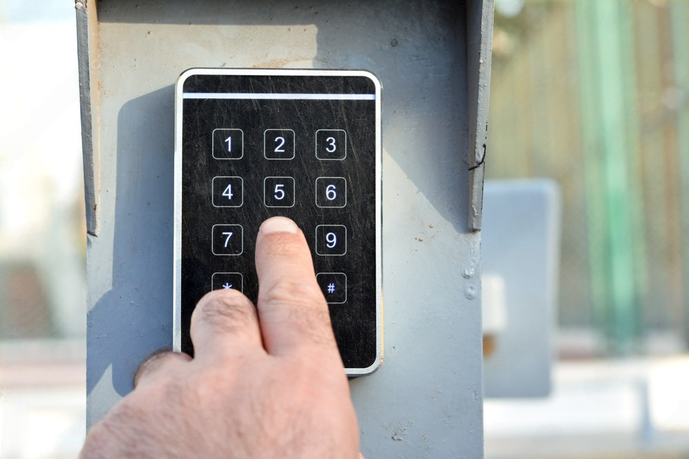 a person is pressing a button on a keypad .
