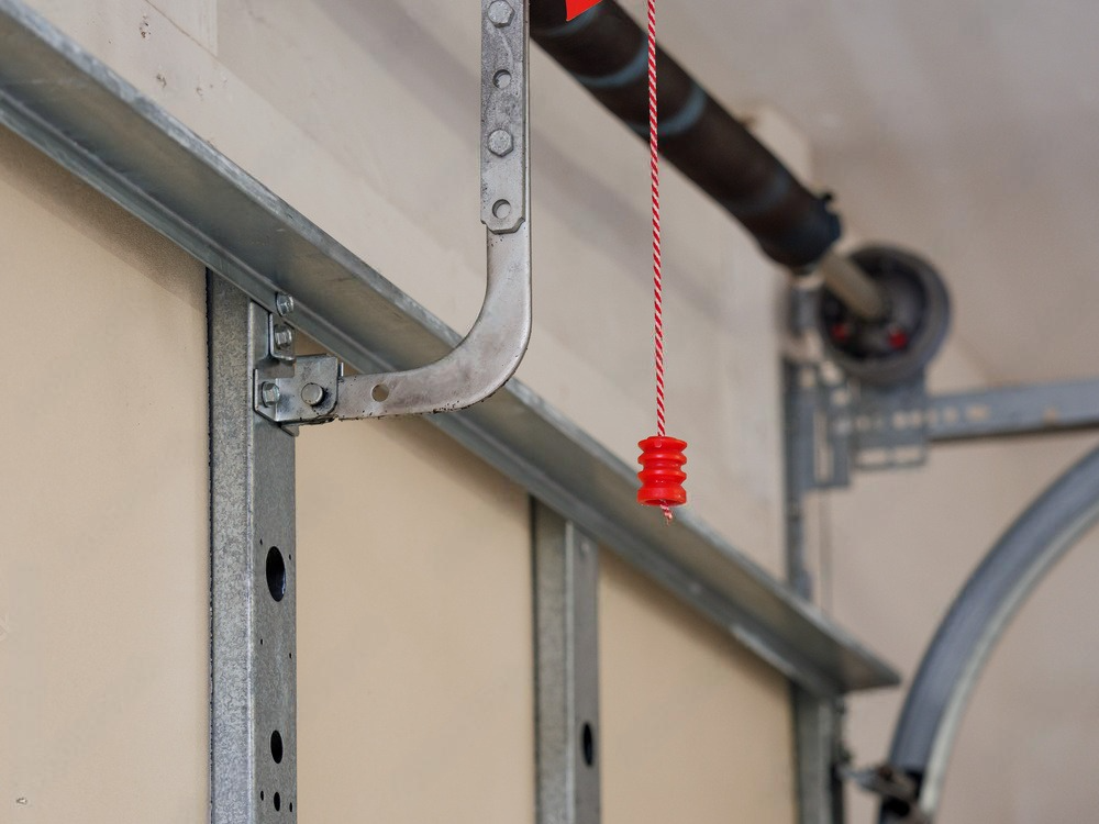 a close up of a garage door with a chain hanging from it