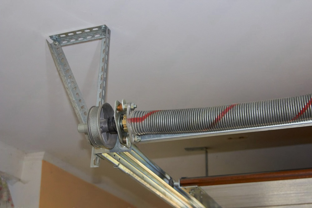 a close up of a garage door spring in a garage .