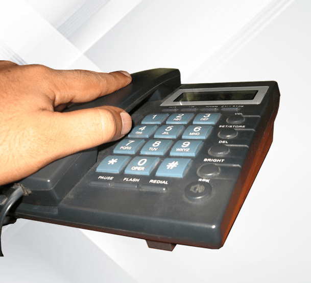 Hand Picking Up Landline Phone — Contact us in Newcastle, NSW