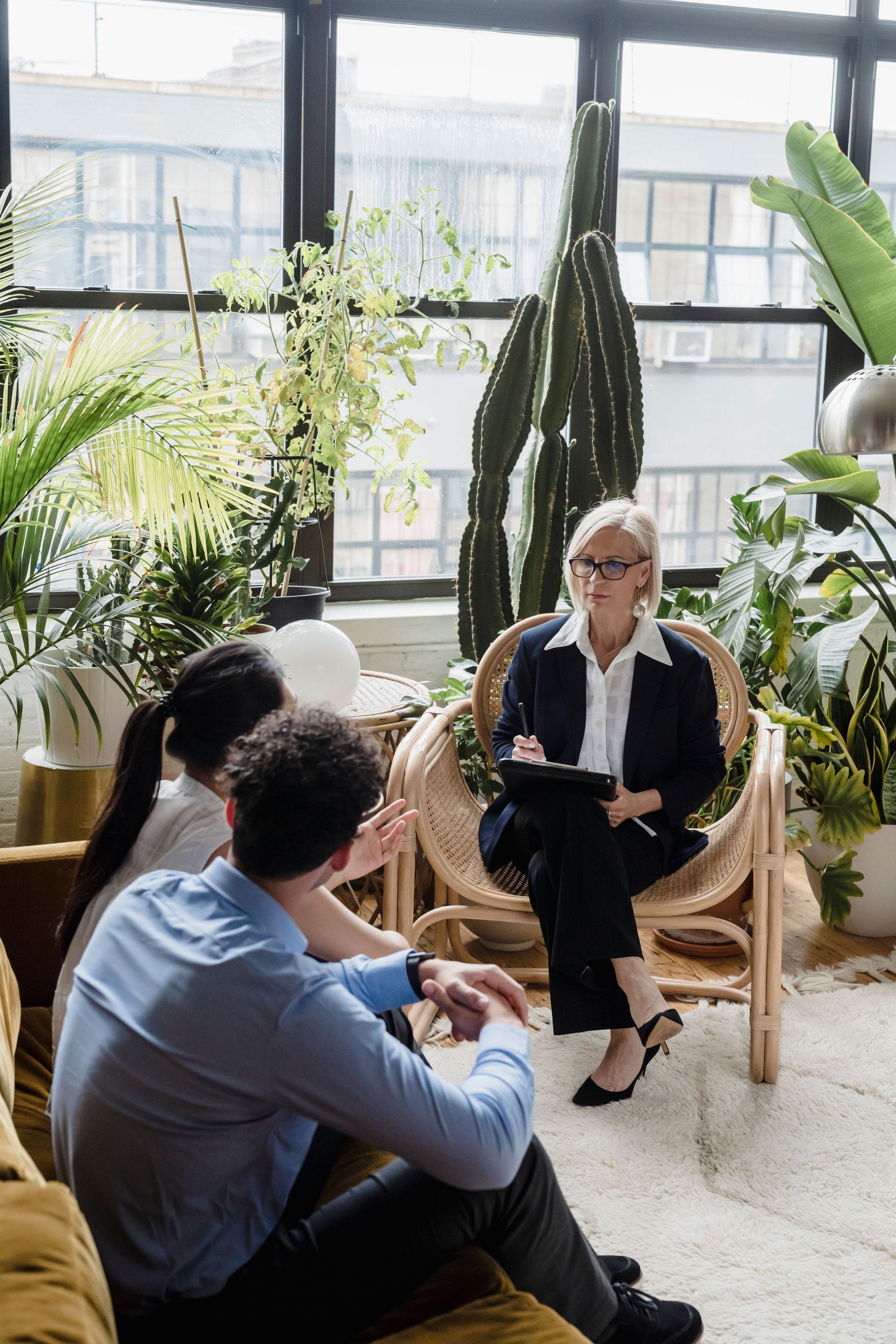 Woman smiling and holding a document during a meeting in a bright office