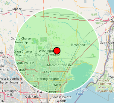 Map with a green radius circle centered on a red dot in the Macomb Township area.