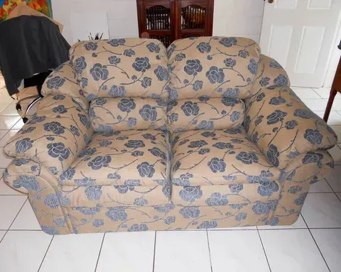 A Couch With Blue Flowers on It Sits on a Tiled Floor — Paulie's Upholstery in Edmonton, QLD