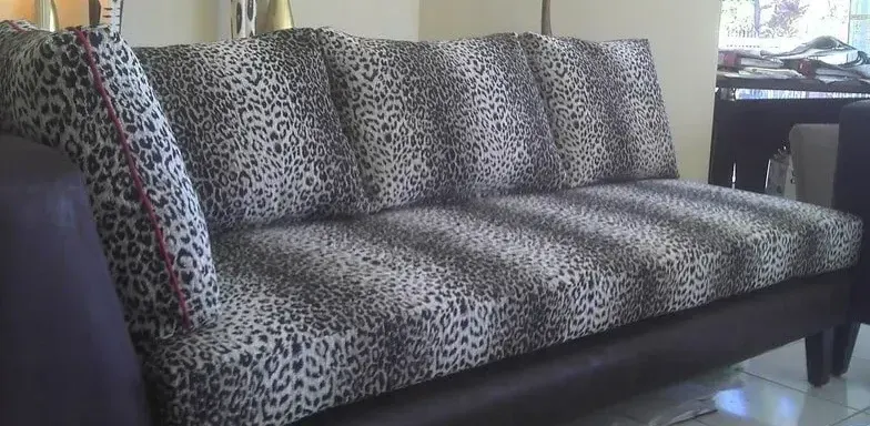 A Leopard Print Couch is in a Living Room — Paulie's Upholstery in Edmonton, QLD