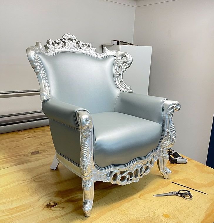 A Silver Chair is on Top of a Wooden Table — Paulie's Upholstery in Edmonton, QLD