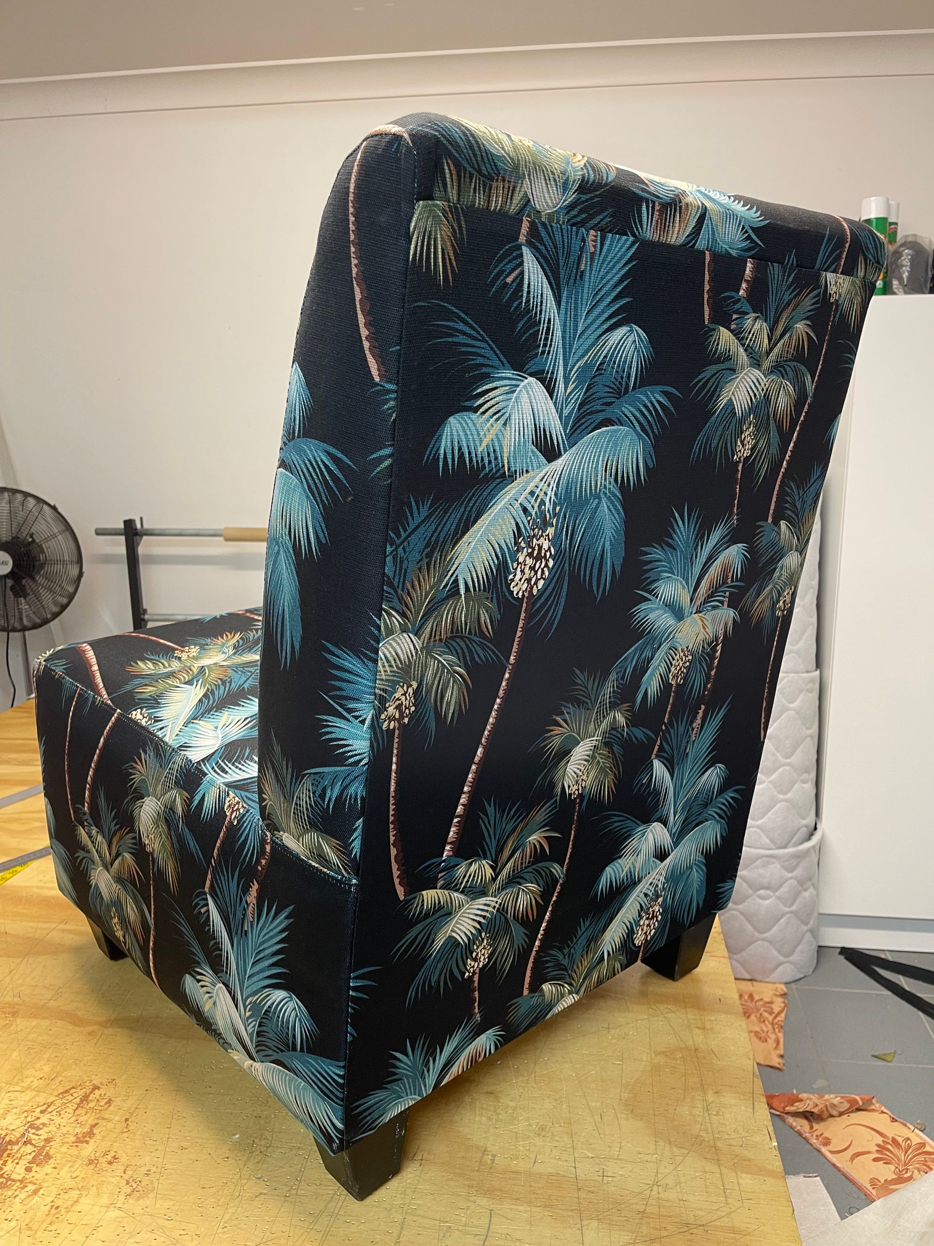A Chair With a Colourful Pattern on It is on a Wooden Table — Paulie's Upholstery in Edmonton, QLD
