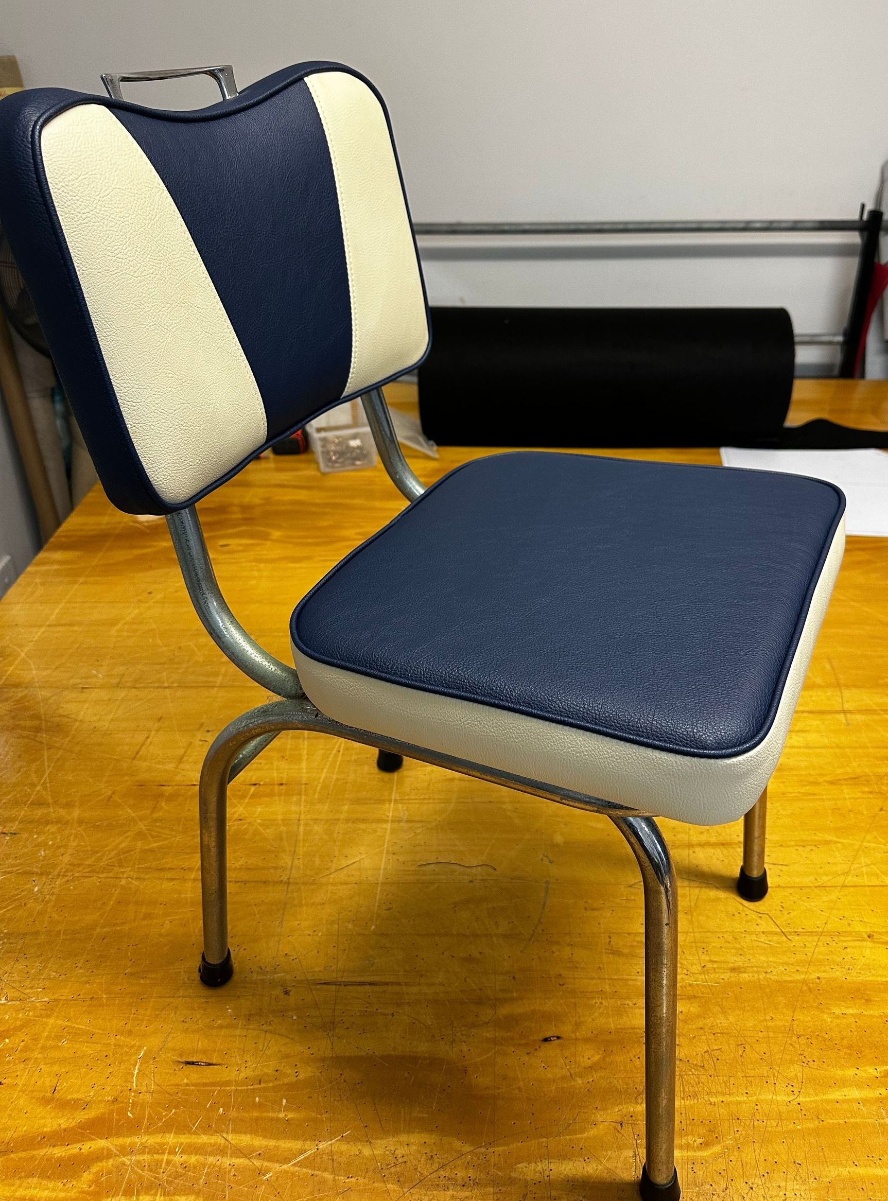 A Chair is on a Wooden Floor in a Room — Paulie's Upholstery in Edmonton, QLD