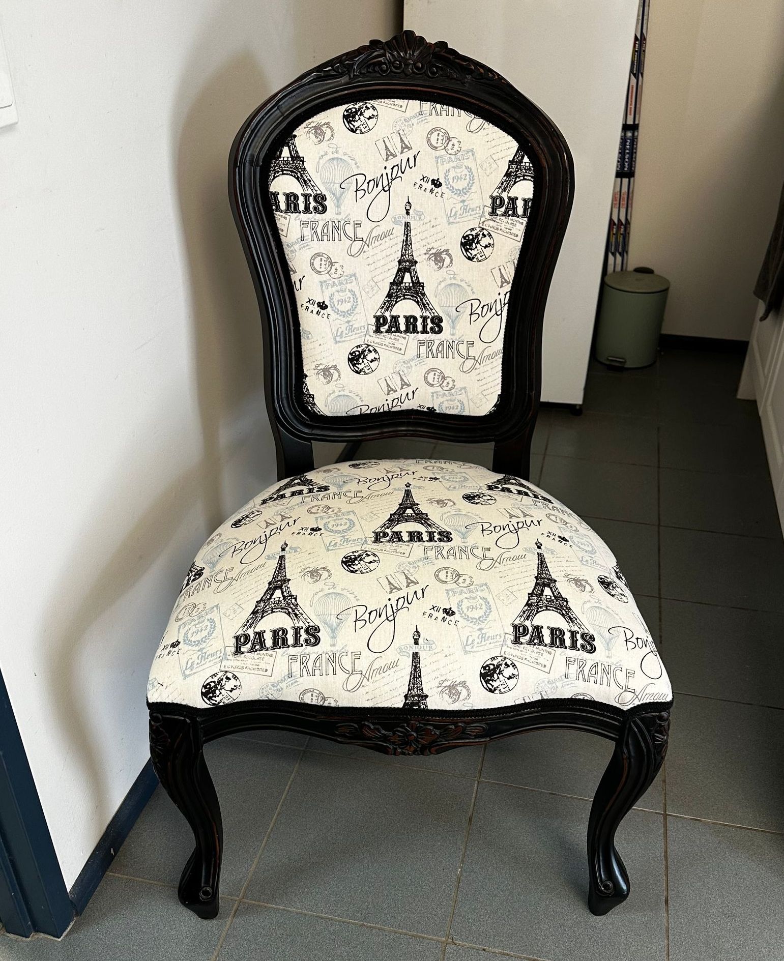 A Black And White Chair Is On A Tiled Floor — Paulie's Upholstery in Edmonton, QLD