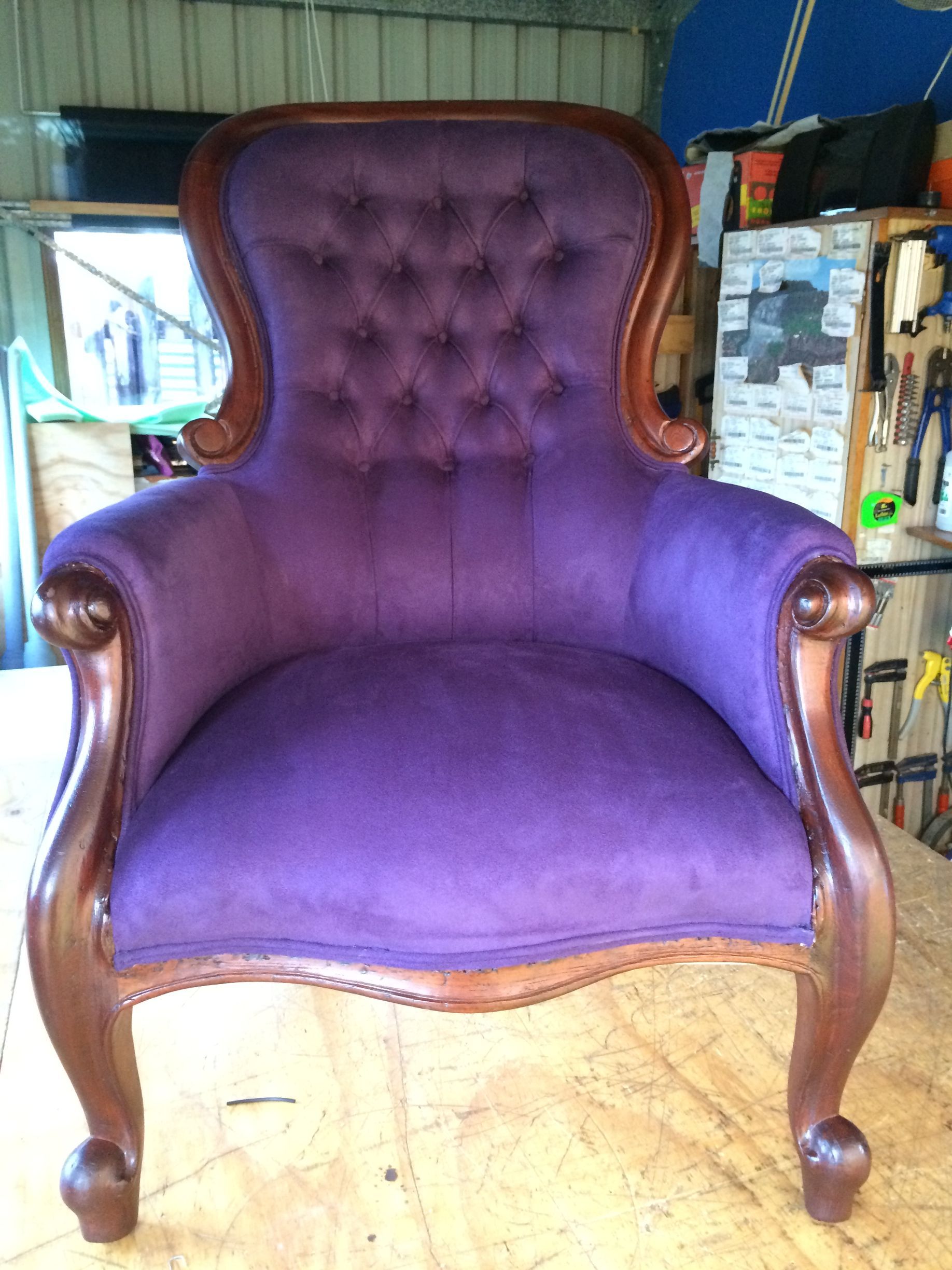 A Purple Velvet Chair is Sitting on a Wooden Floor — Paulie's Upholstery in Edmonton, QLD