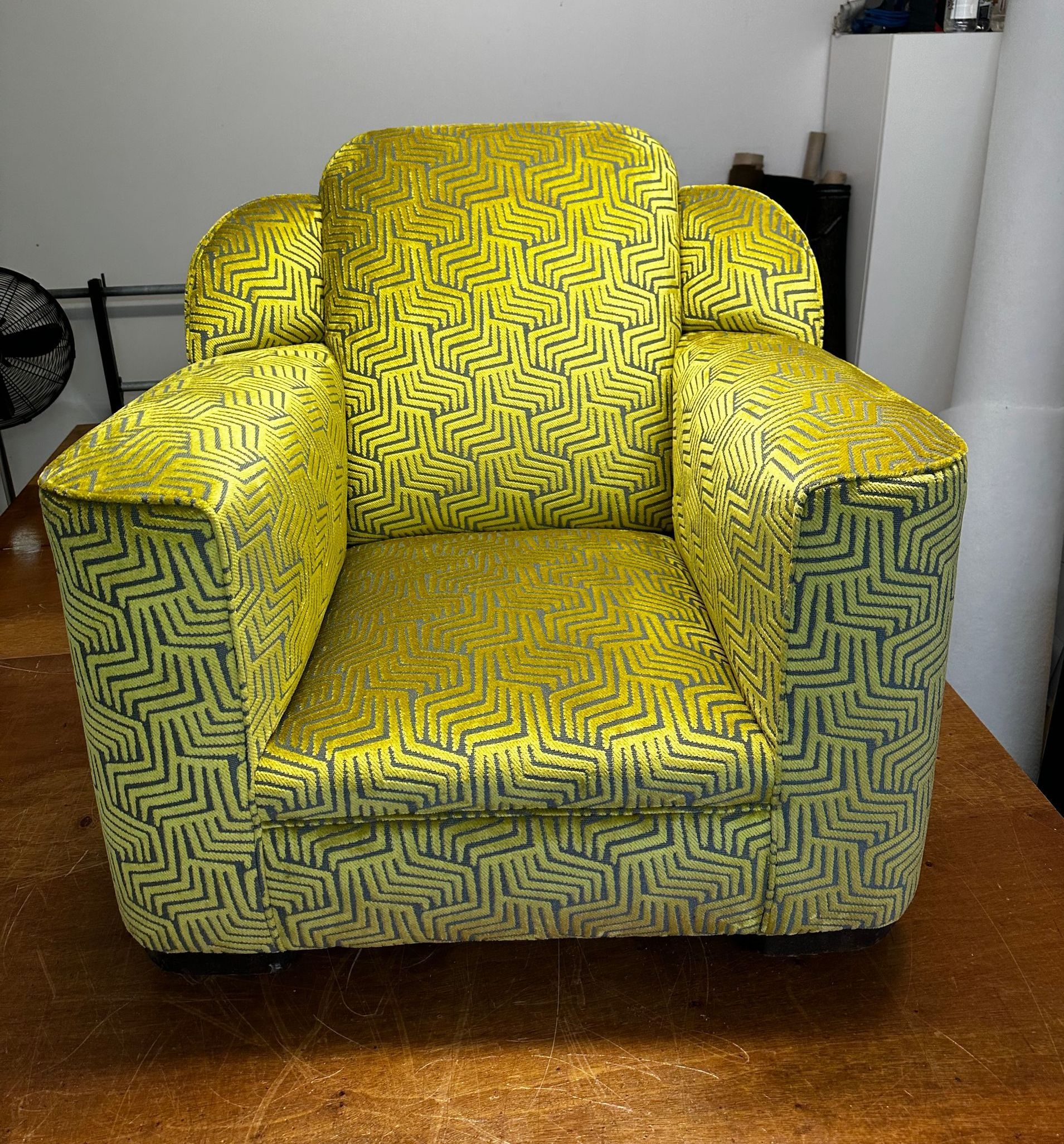 A Yellow Recliner Chair On Wooden Floor — Paulie's Upholstery in Edmonton, QLD