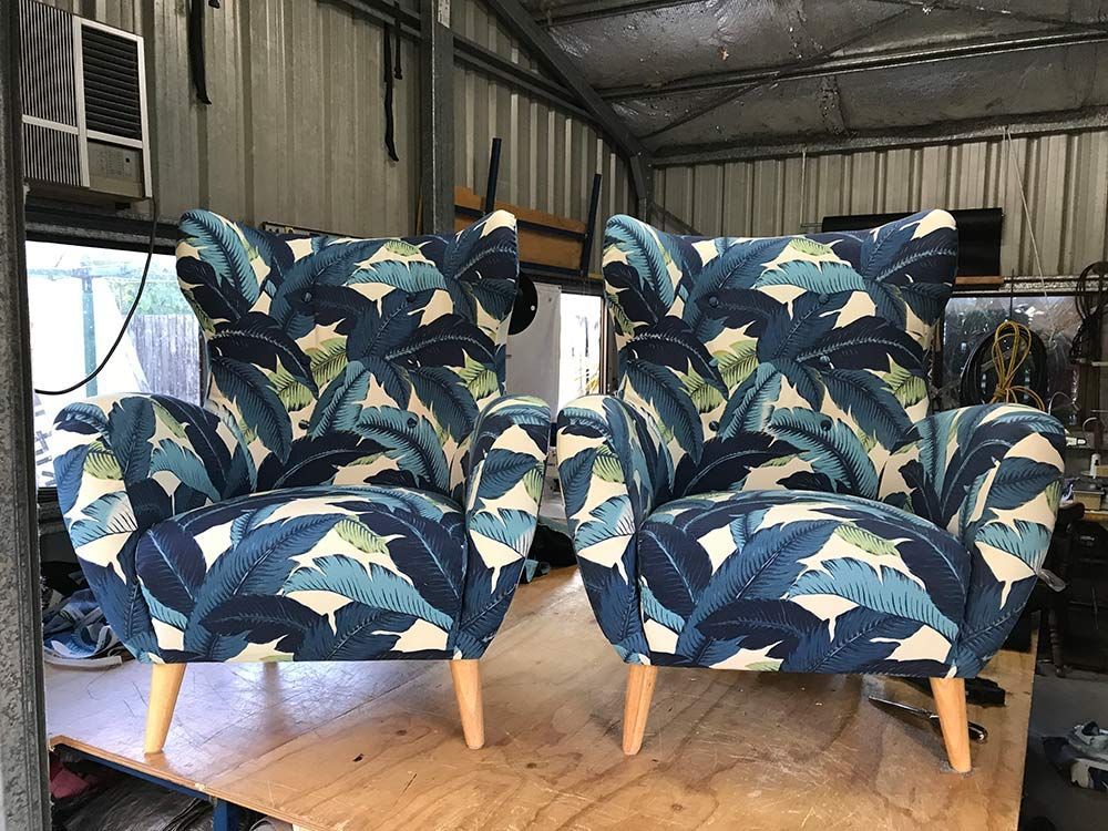 Two Chairs With Blue Leaves on Them Are on a Wooden Table — Paulie's Upholstery in Gordonvale, QLD