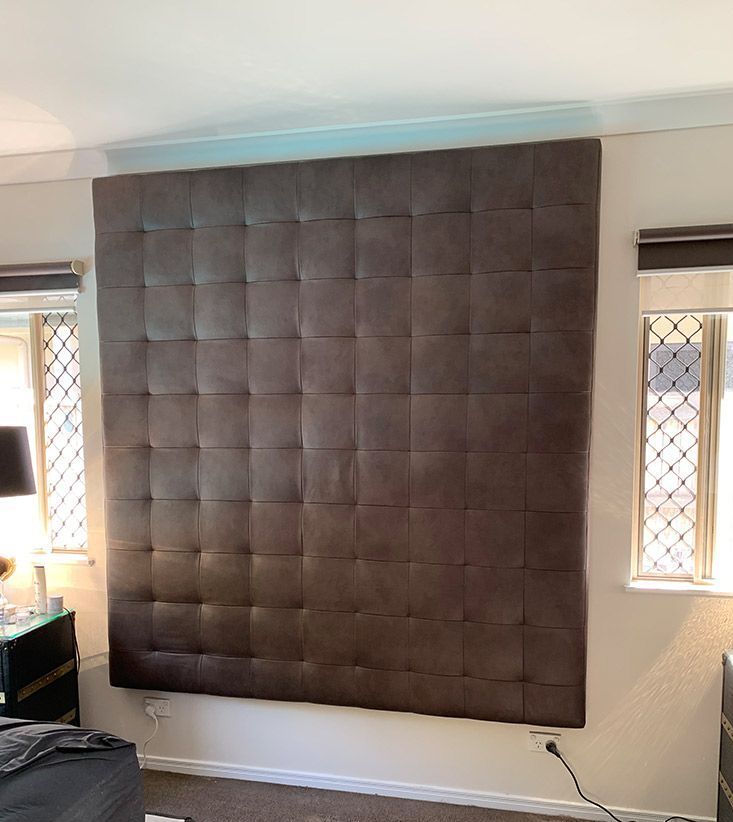 A Bedroom With a Large Brown Headboard and Two Windows — Paulie's Upholstery in Edmonton, QLD