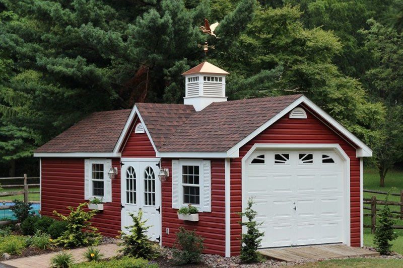 red and white garage a red and white garage with a weather vane on top