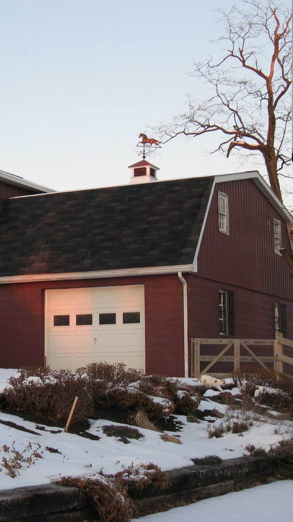 Red barn cupola and weathervane a red barn with a weather vane on top of it