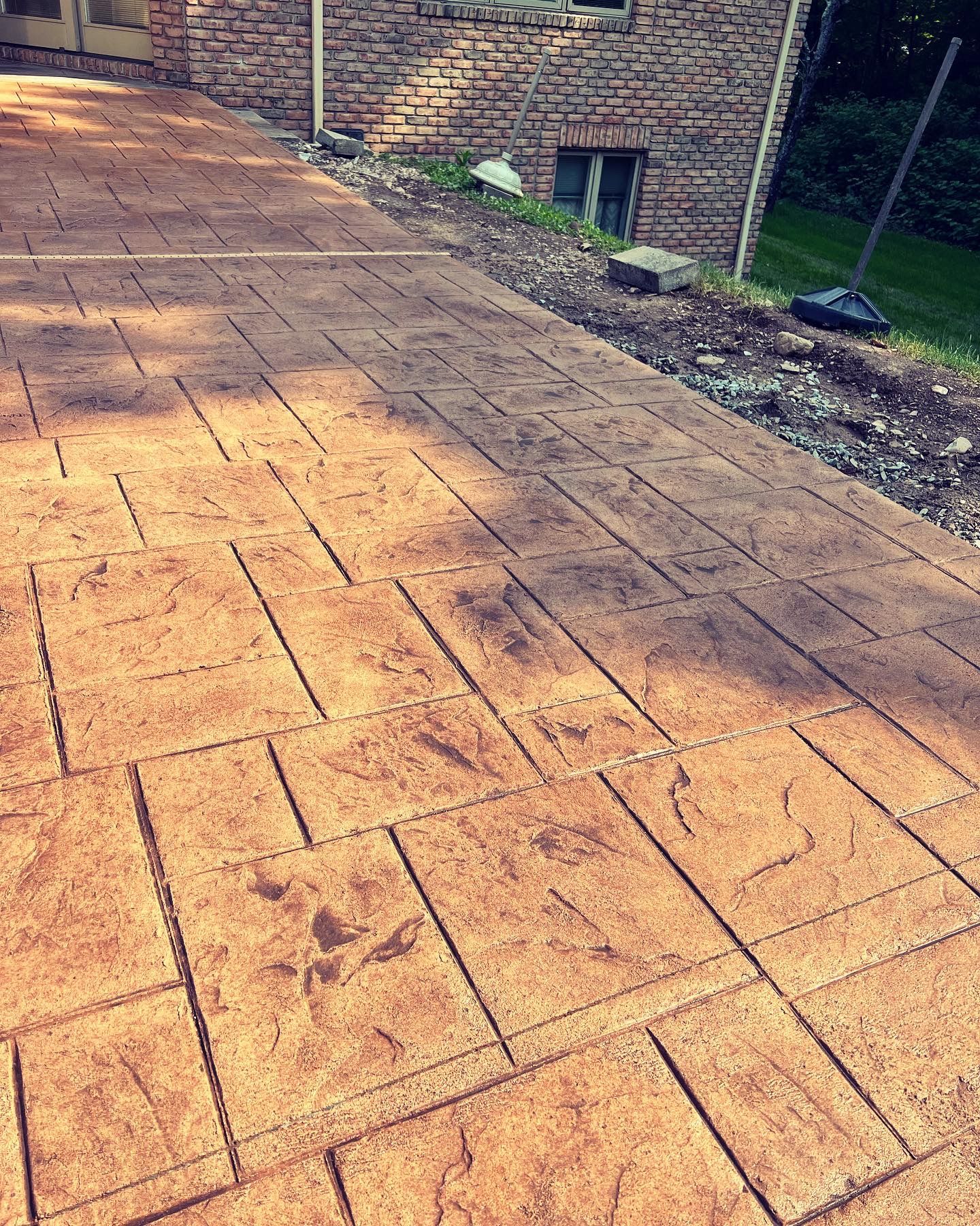 A brick walkway with a brick building in the background.