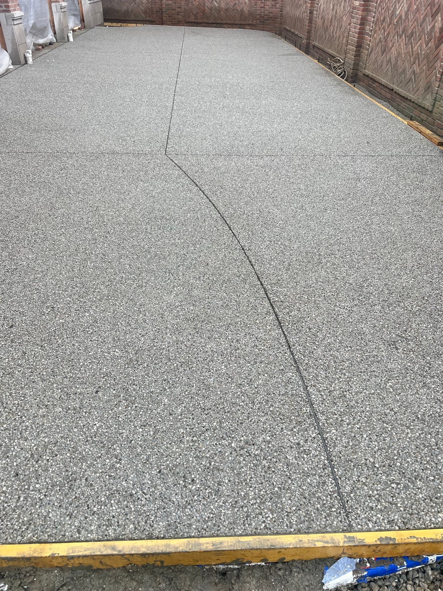A large pile of gravel is sitting on top of a concrete floor.