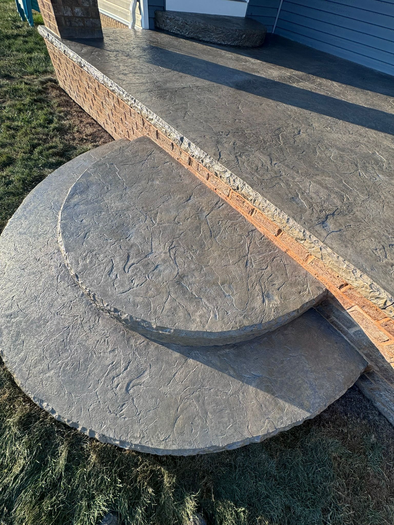 A set of concrete steps sitting on top of a grass covered field.
