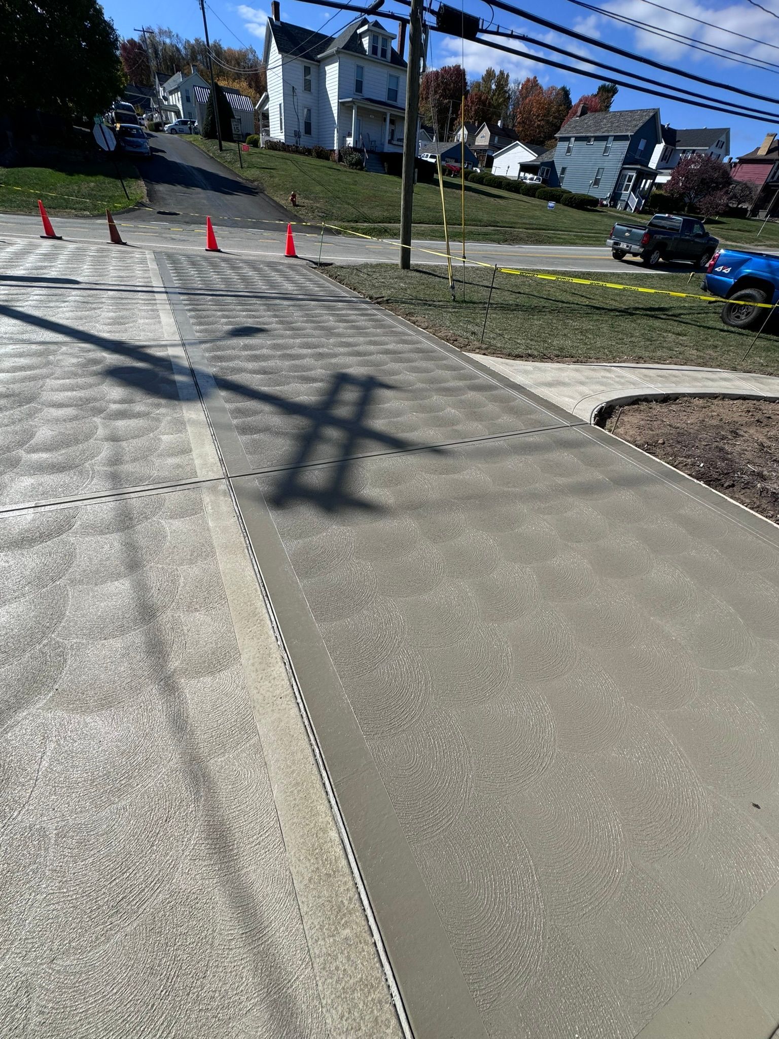 A concrete sidewalk is being built on the side of a road.