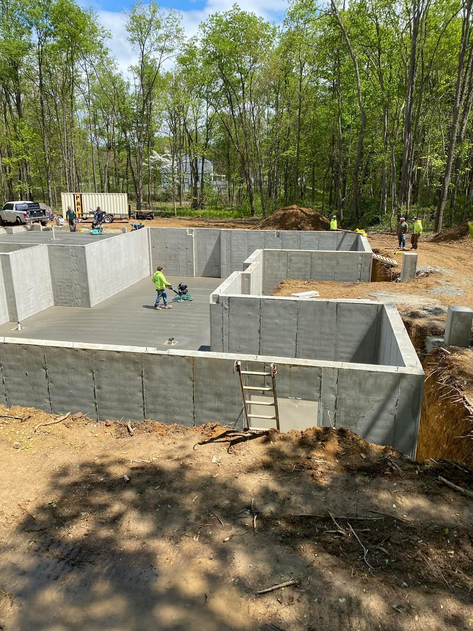 A concrete foundation is being built in the middle of a forest.