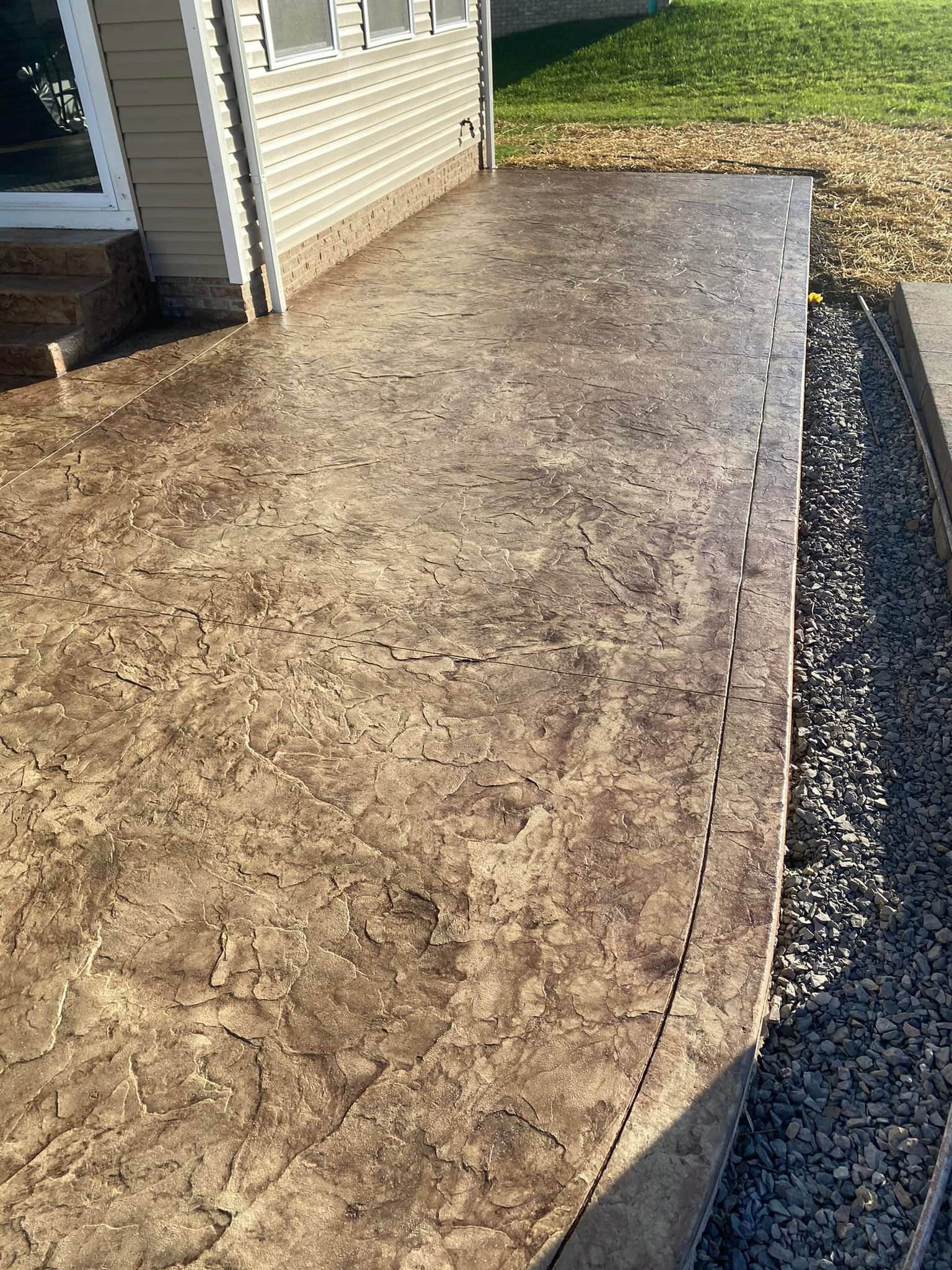 A close up of a concrete patio in front of a house.