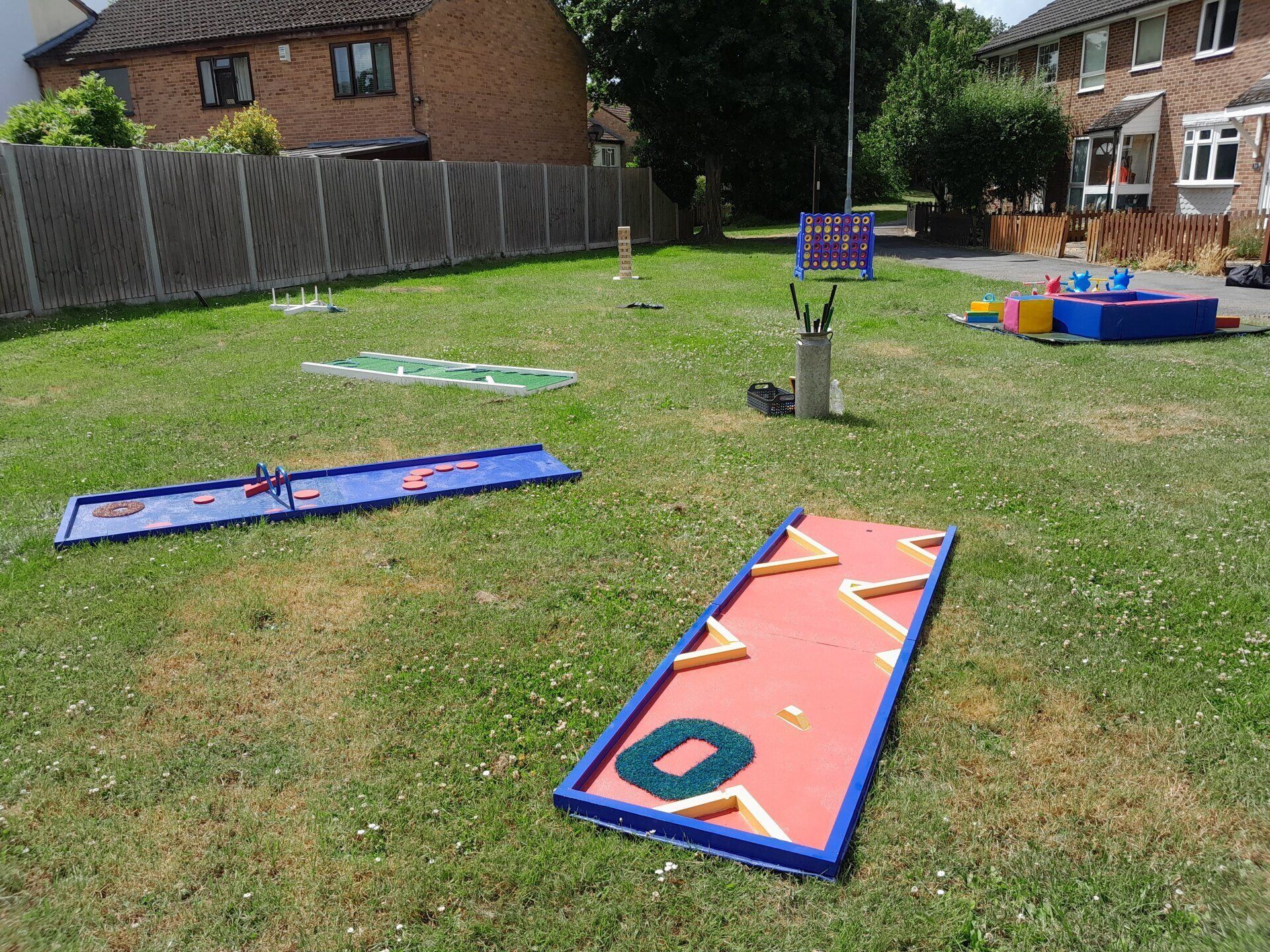 Mini golf set up with other lawn games on a open green for a birthday party.