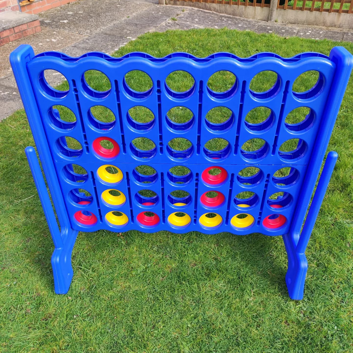 Giant plastic connect 4 lawn game on grass
