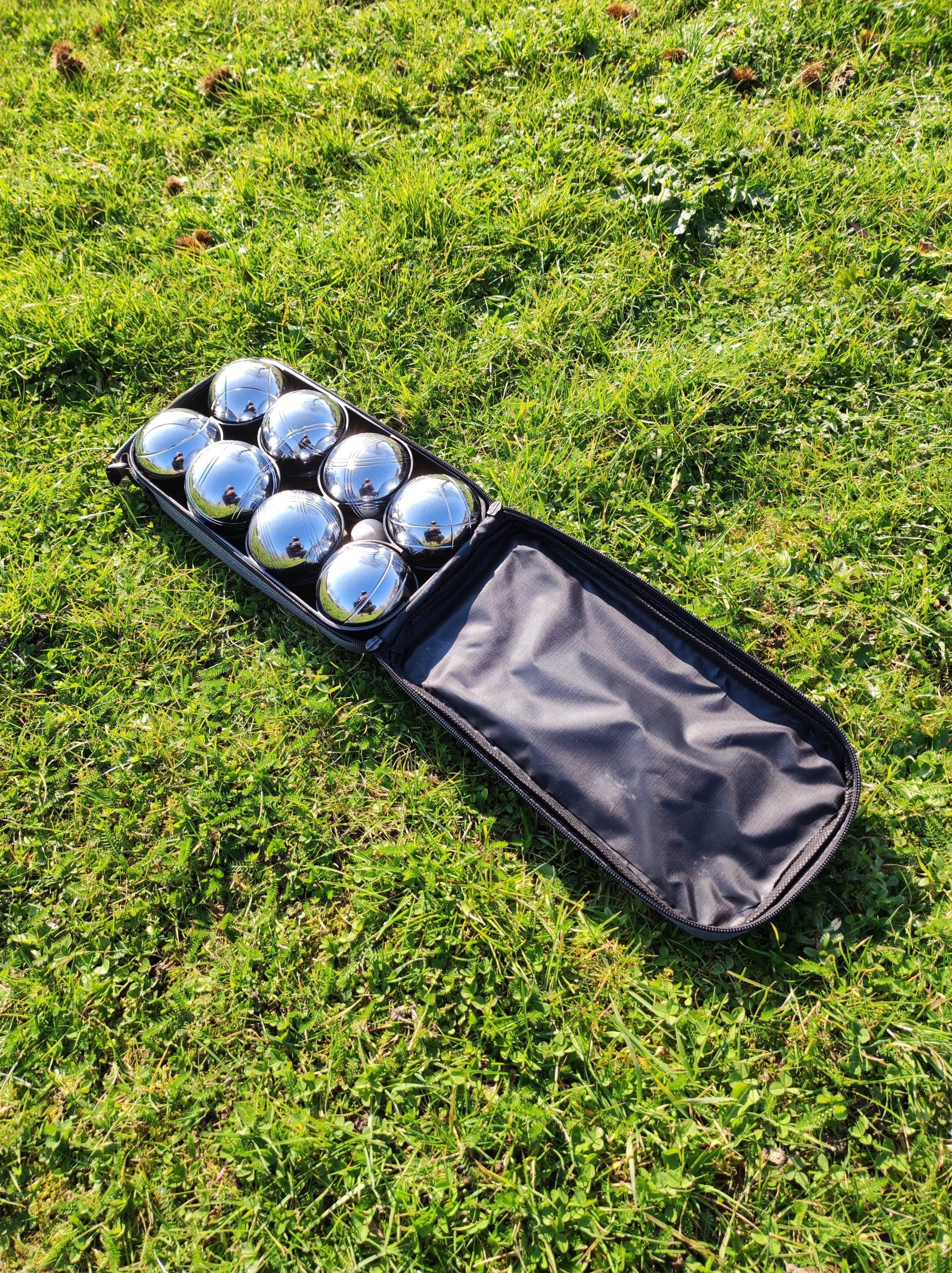 8 French Boules balls in a carry case on green grass