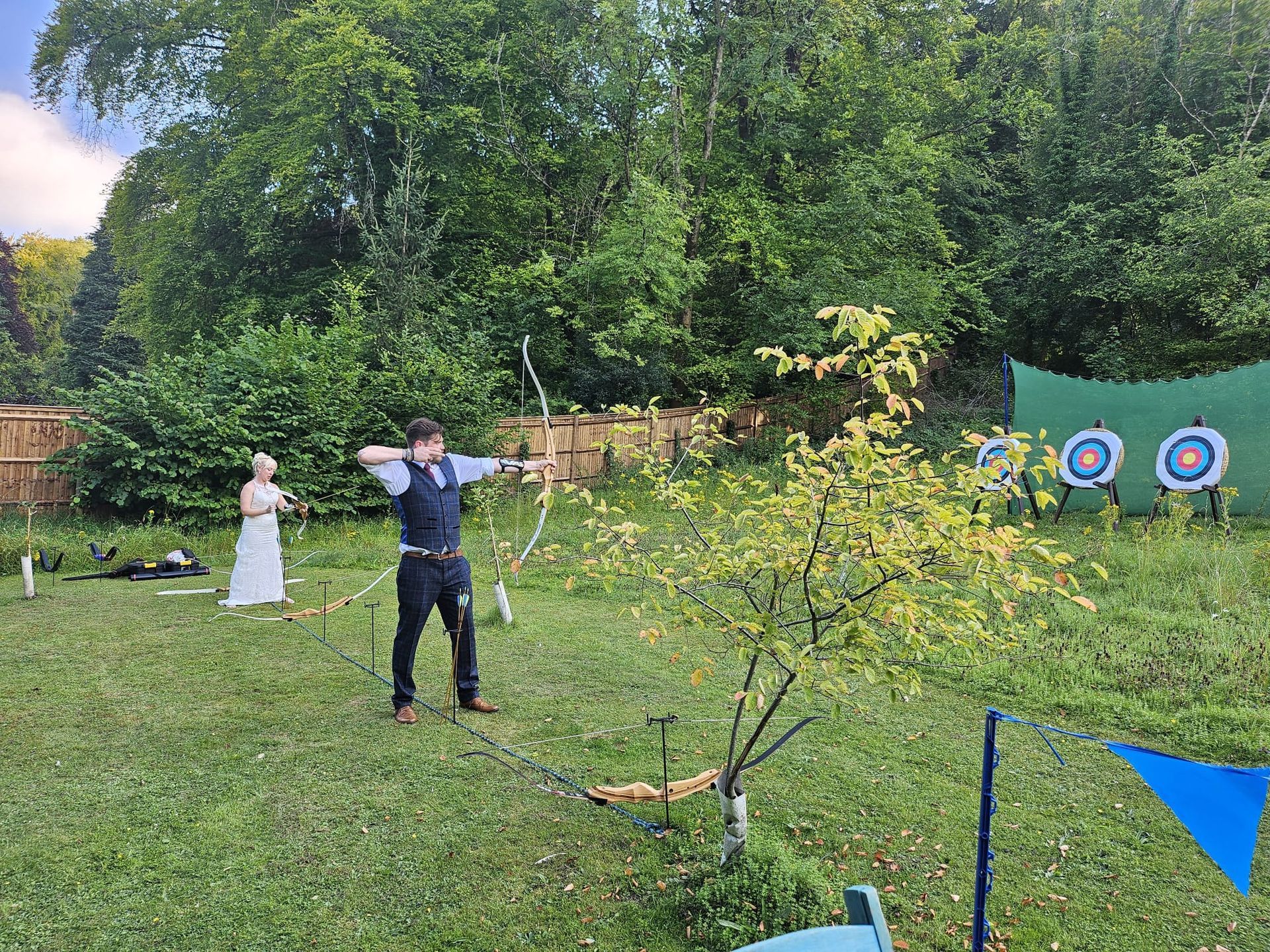 Archery hire in Hampshire, people holding bows and others watching