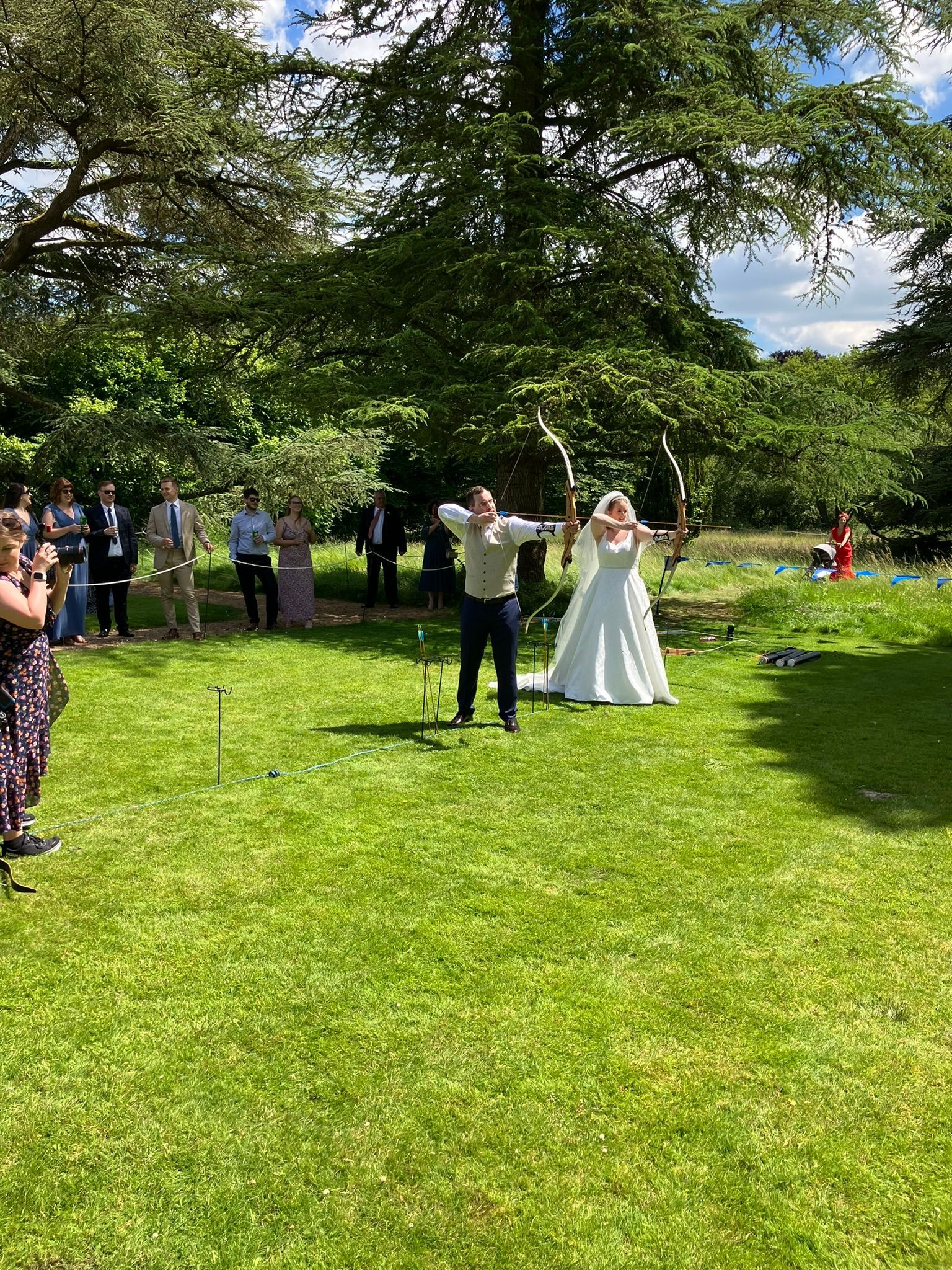 Archery hire in Hampshire, people holding bows and others watching