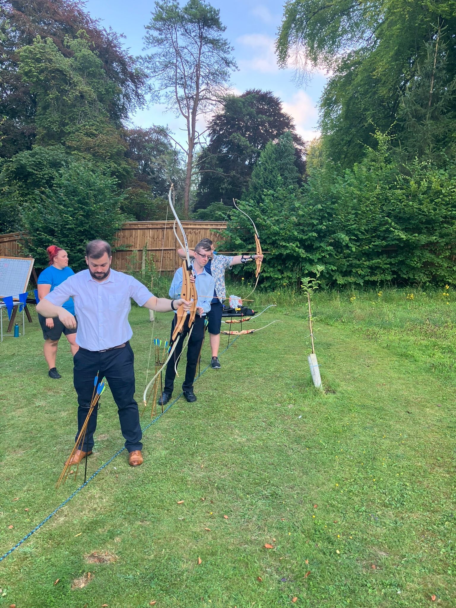 Archery hire in Hampshire, people holding bows and others watching