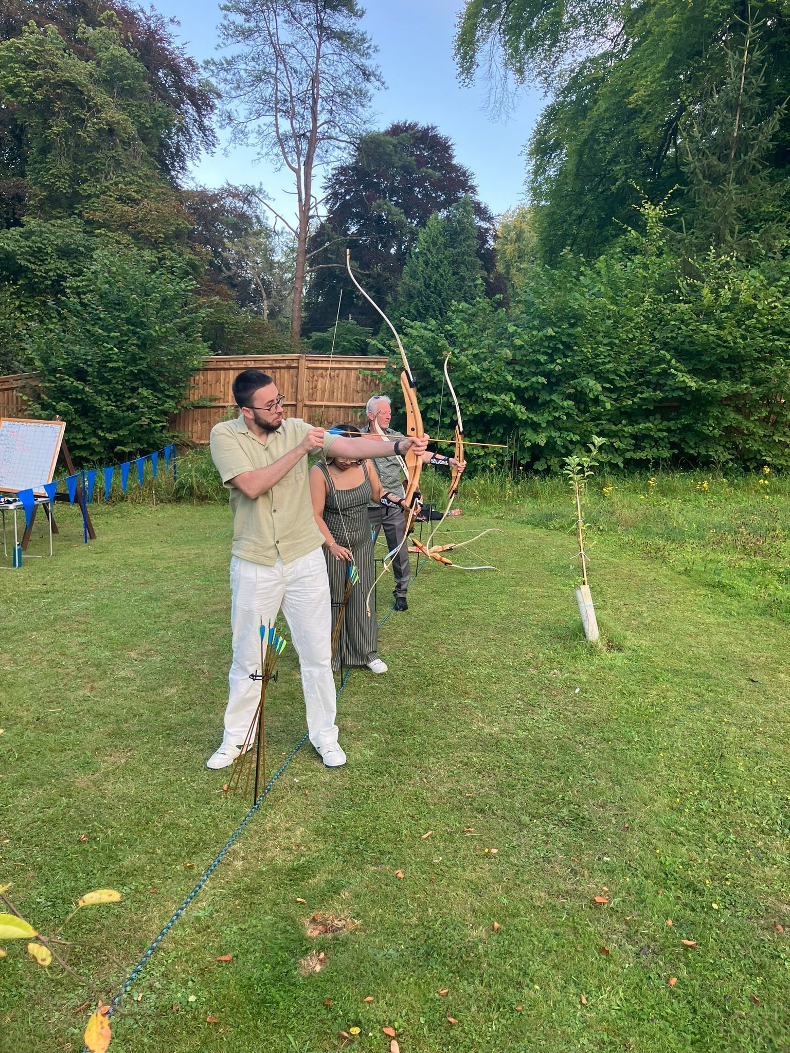 Archery hire in Hampshire, people holding bows and others watching