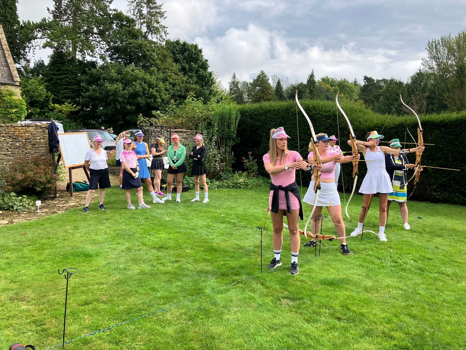 Archery hire in Hampshire, people holding bows and others watching