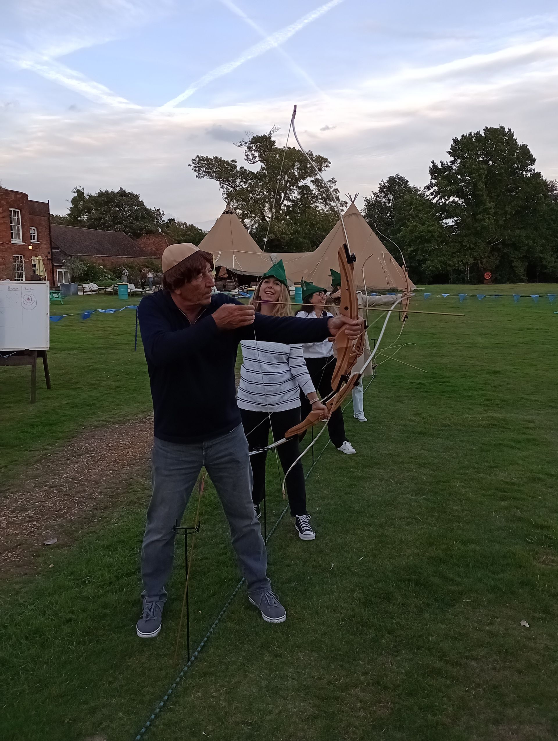 Robin Hood theme corporate archery at Stoke Place hotel. 4 group members holding archery bows.