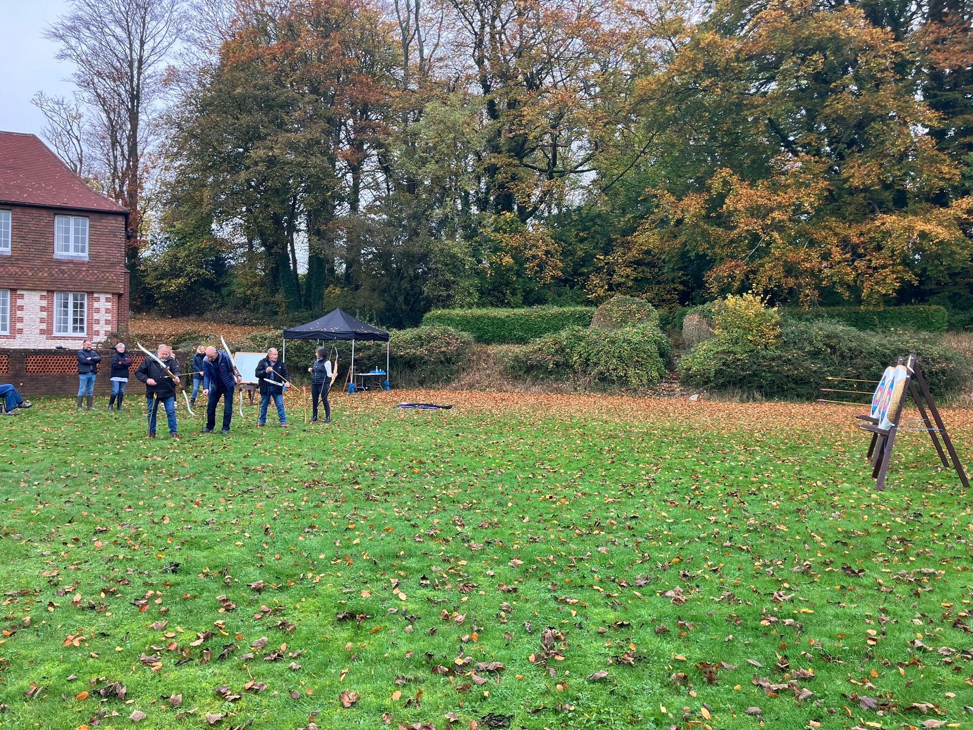 two archery targets set up in a field in Hampshire with 4 people aiming